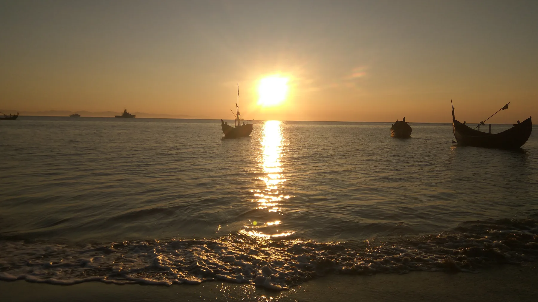 Sunset over the sea with fishing boats at Saint Martin's Island